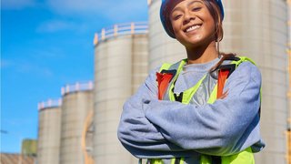 Woman engineer smiling infront of her work