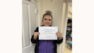Learner holding her certificate