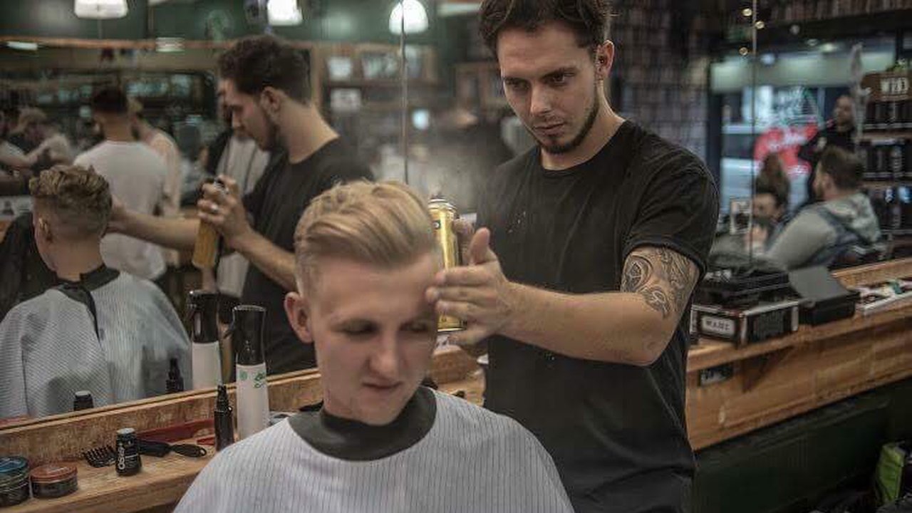 A barber cutting a customers hair