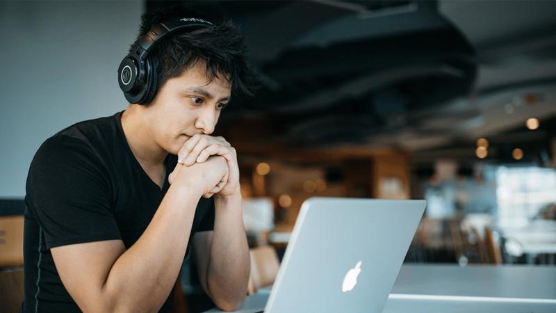 A man sat on his laptop