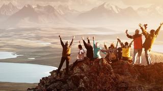 People celebrating their success on the top of a mountain