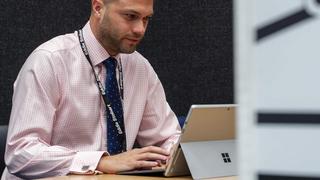 Male professional on laptop.