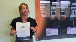 apprentice holding a special recognition award
