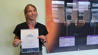 apprentice holding a special recognition award