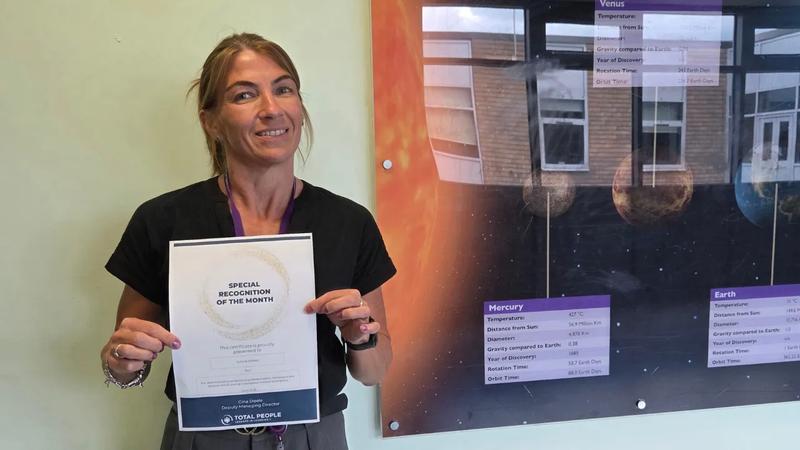 apprentice holding a special recognition award