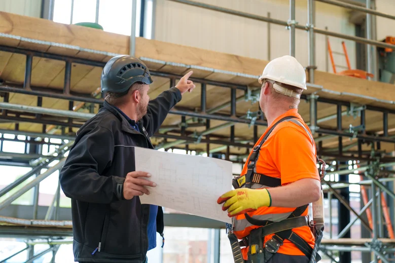 Two engineers working together on a plan