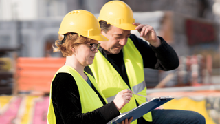 Two engineers looking at plans