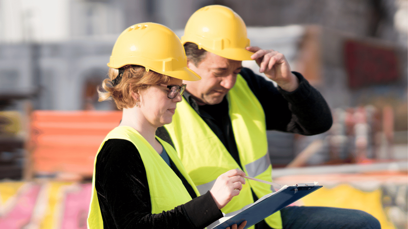 Two engineers looking at plans