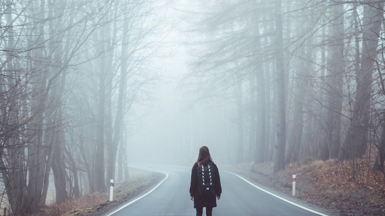 Woman stood alone in the fog