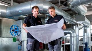 Two people looking at a diagram