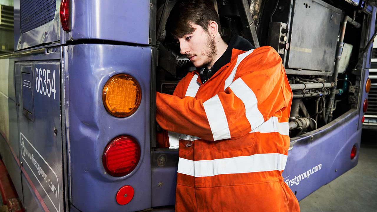 Commercial vehicle apprentice repairing a bus.