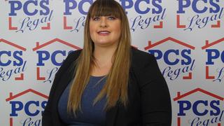 Kate Forsdike stood in front of a background covered in the PCS Legal logo.