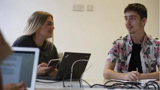 A male and female employee in an office.