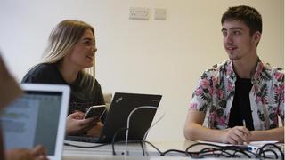 A male and female employee in an office.