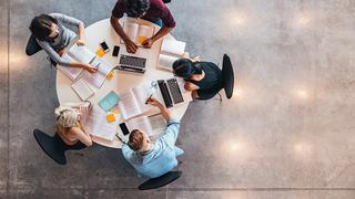 Ariel view of apprentices working around a table