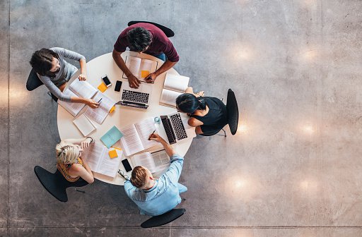 Ariel view of apprentices working around a table