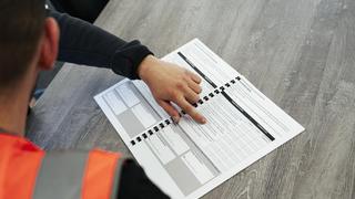 An over the shoulder view of two people looking at a document