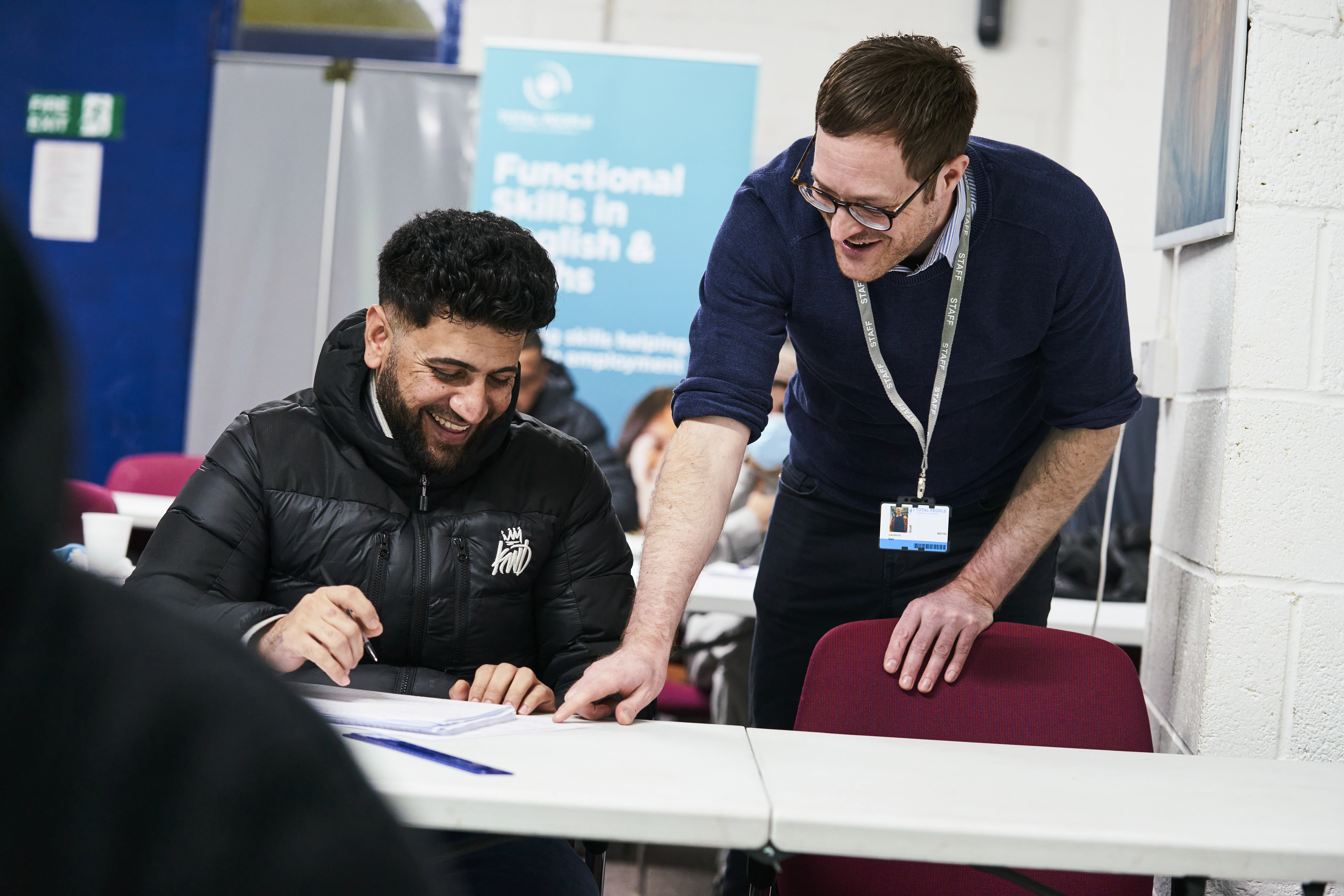 teacher and student looking at book