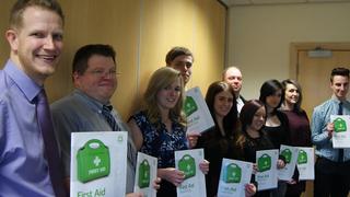 A group of people who have recently passed their first aid course