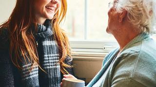 Woman helping an elderly lady