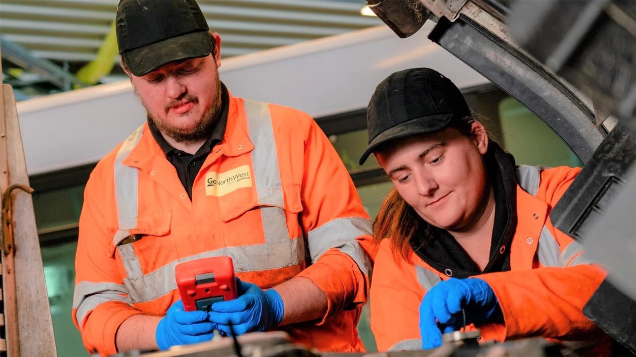 Two bus and coach engineers working together