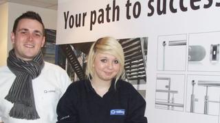 Two people smiling at the camera