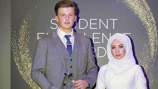 Two students with their awards