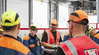 group of apprneitces having a meeting in a workshop