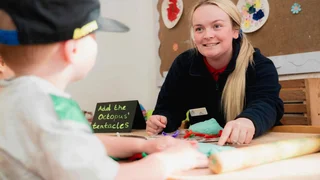 early years learner playing with a child