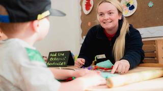 early years learner playing with a child