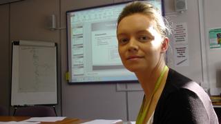 Teacher teaching her class