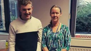 Two people smiling at the camera