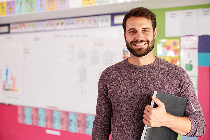 man holding a file smiling a the camera