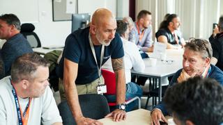 Adult learners taking part in a group discussion during a classroom training session.