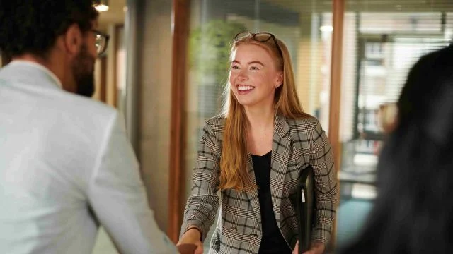 A woman shaking hands after an interview