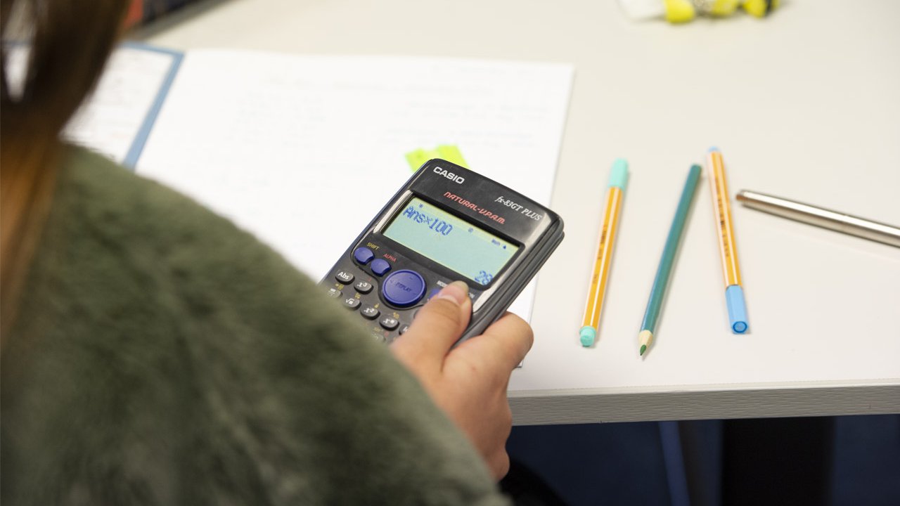 Apprentice holding a calculator