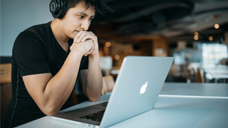 A man sat on his laptop