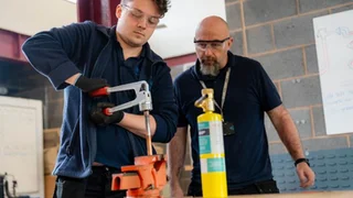 Employer observing an apprentice