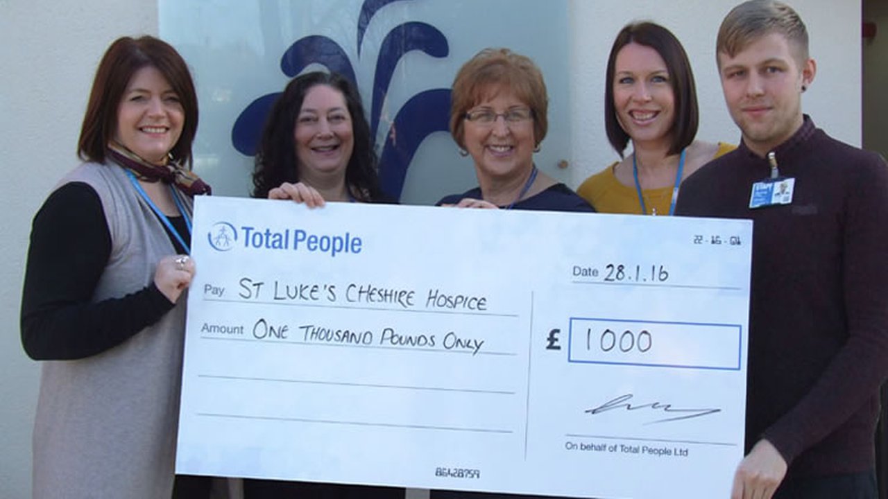 Total People handing over a cheque to St Luke's Cheshire Hospice